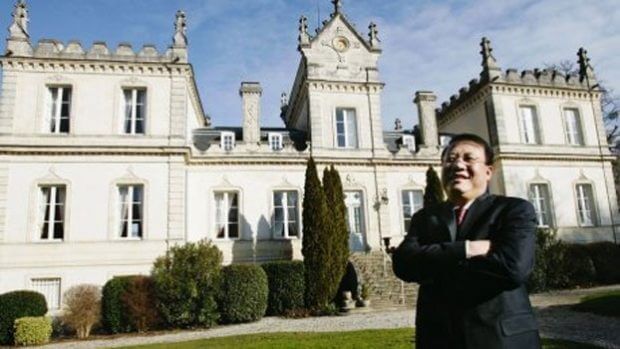 A person standing in front of a buildingDescription automatically generated